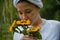 Girl holding a bouquet of sunflowers outdoor.