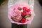 Girl holding bouquet of tender bright pink flowers