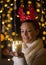 Girl holding candle and celebrating Christmas