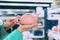 Girl holding a ceramic pink teapot in a supermarket