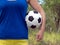 Girl holding a classical football colorful sports ball for soccer. Closeup Photo