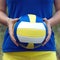 Girl holding a colorful sports ball for volleyball. Closeup Photo