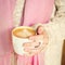 Girl holding a cup of coffee or hot chocolate or chai tea latte.