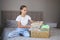 Girl holding donation box with with summer clothes. Selective focus on things in the box