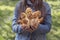 A girl is holding edible spring mushrooms in the hands