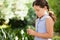 Girl holding flower standing at backyard