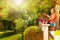 Girl holding flowerpot with plant on the terrace