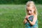 Girl holding grasshopper, curiosity and education concept