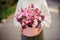 Girl holding a huge pink box of different rose color flowers