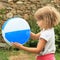 Girl holding inflating ball