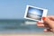 Girl Holding Instant Photo Of Sea Beach