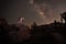 Girl Holding Lantern in the Desert Under the Milky Way