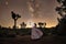 Girl Holding Lantern in the Desert Under the Milky Way
