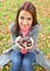 Girl holding many chestnuts in her hands in autumn