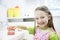 Girl holding model of human jaw with dental braces