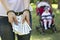 A girl is holding money dollars in handcuffs against the backdrop of a baby in a carriage, arrest,trafficking in children