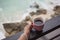 Girl holding mug of hot coffee. Balcony at seaside