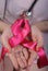 Girl holding in the palm pink ribbon