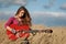 Girl holding playing guitar in field