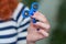 A girl is holding a popular toy fidget spinner in her hands. Stress relief. Anti stress and relaxation fidgets spinner.
