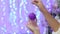 A girl is holding a purple Christmas ball,close-up