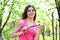 Girl holding a skipping rope in a summer park