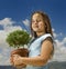 Girl holding small tree