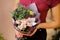 Girl holding a stylish bouquet of roses, orchid, eucalyptus