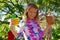 Girl holding tropical drinks at a Hawaiian luau