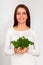 Girl holding two bunches of parsley near the face