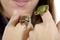 Girl holding two Oregon tree frogs up close