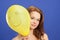 Girl holding yellow smiling balloon