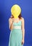 Girl holding yellow smiling balloon