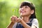 A girl holding a young plant in her hands with a hope of good environment