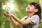 A girl holding a young plant in her hands with a hope of good environment