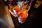 Girl holds alcoholic cocktails negroni with ice and dried honeycombs