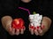 Girl holds an apple and a glass with sugar, human choice, healthy and junk food