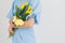 Girl holds a bouquet of tulips and Easter ginger cookies