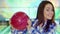 Girl holds bowling ball near her face