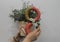 The girl holds the decor in her hands - a flower pot and figure eight,