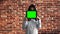 The girl holds a digital tablet with a chromakey in front of her face, below her eyes. A teenage girl in a white blouse