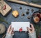 Girl holds an envelope with congratulations for a new year or Christmas, next to is a packed gift, tangerines, packing materials,