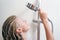 Girl holds hand watering a shower