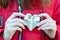 Girl holds a heart in her hands. Heart made of money. out of focus