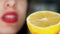 girl holds in her hand a cut half of yellow juicy lemon