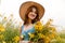 The girl holds in her hands a bouquet of rapeseed and spikelets of wheat