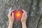 Girl holds her hands in protection gesture for saving nature.