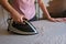 Girl holds iron on ironing board and irons things