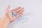 Girl holds in the palm of her hand a pill on white isolated background. medicine, paracetamol