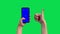 The girl holds a phone with a blue screen on the chromakey and gives a thumb up. A woman`s hand with a red manicure